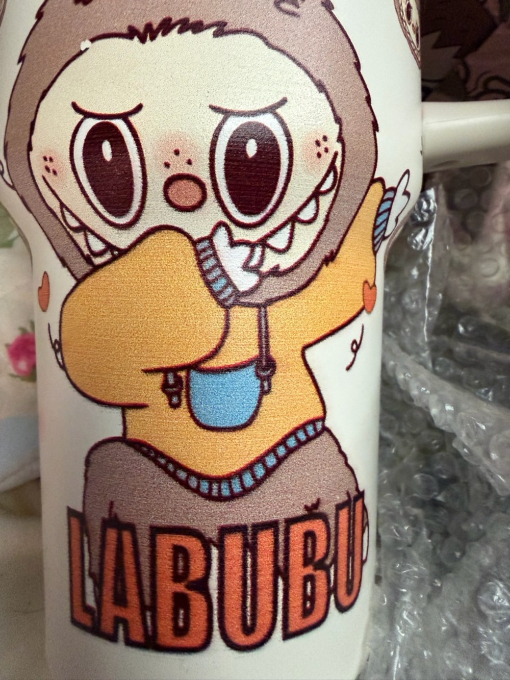 Stanley Labubu Cream Travel Mug with Playful Character and Orange Accents